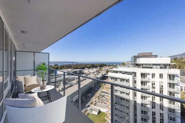 Spacious private balcony at Gateway Residences offering panoramic ocean and mountain views overlooking Park Royal in West Vancouver.